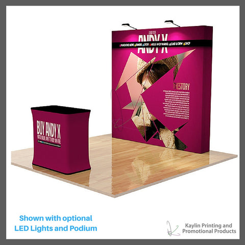 KYN-TSD-001 Tradeshow Display with 8 foot straight shape and vibrant graphics printed on fabric. Velcro attached. Personalized with your custom imprint or logo. Shown with optional LED Lights and Podium.